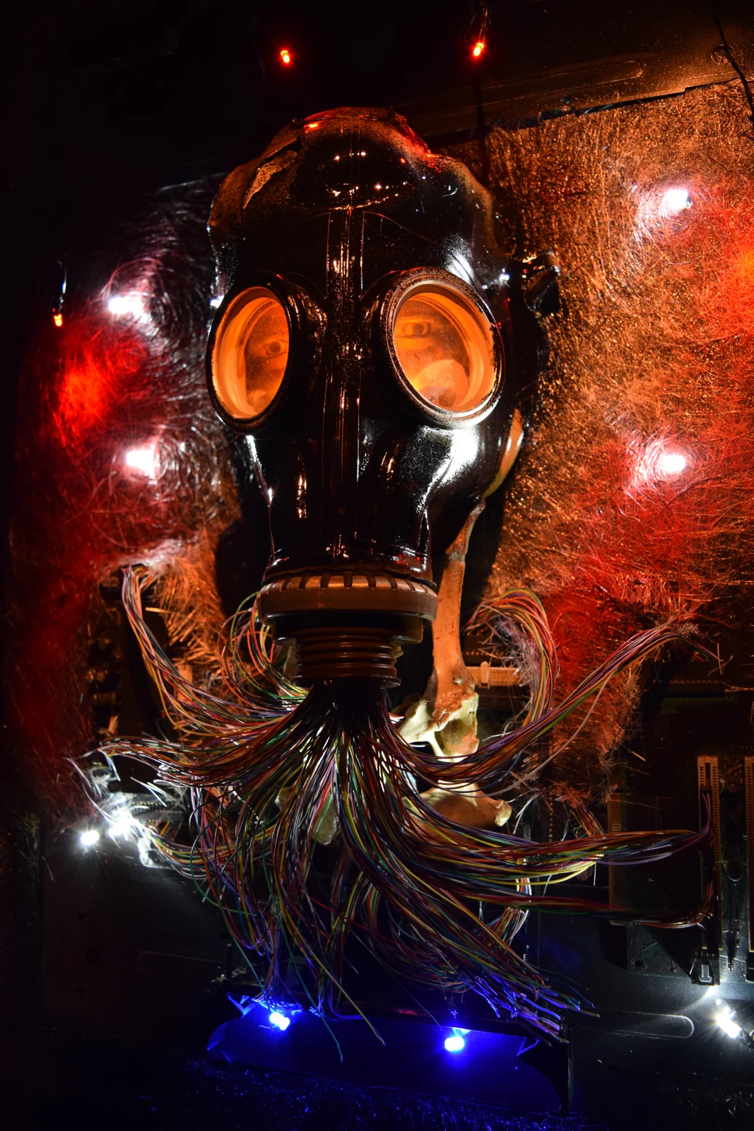 Machinarium — a gas mask trailing a mane of multicoloured wires, lit red and blue